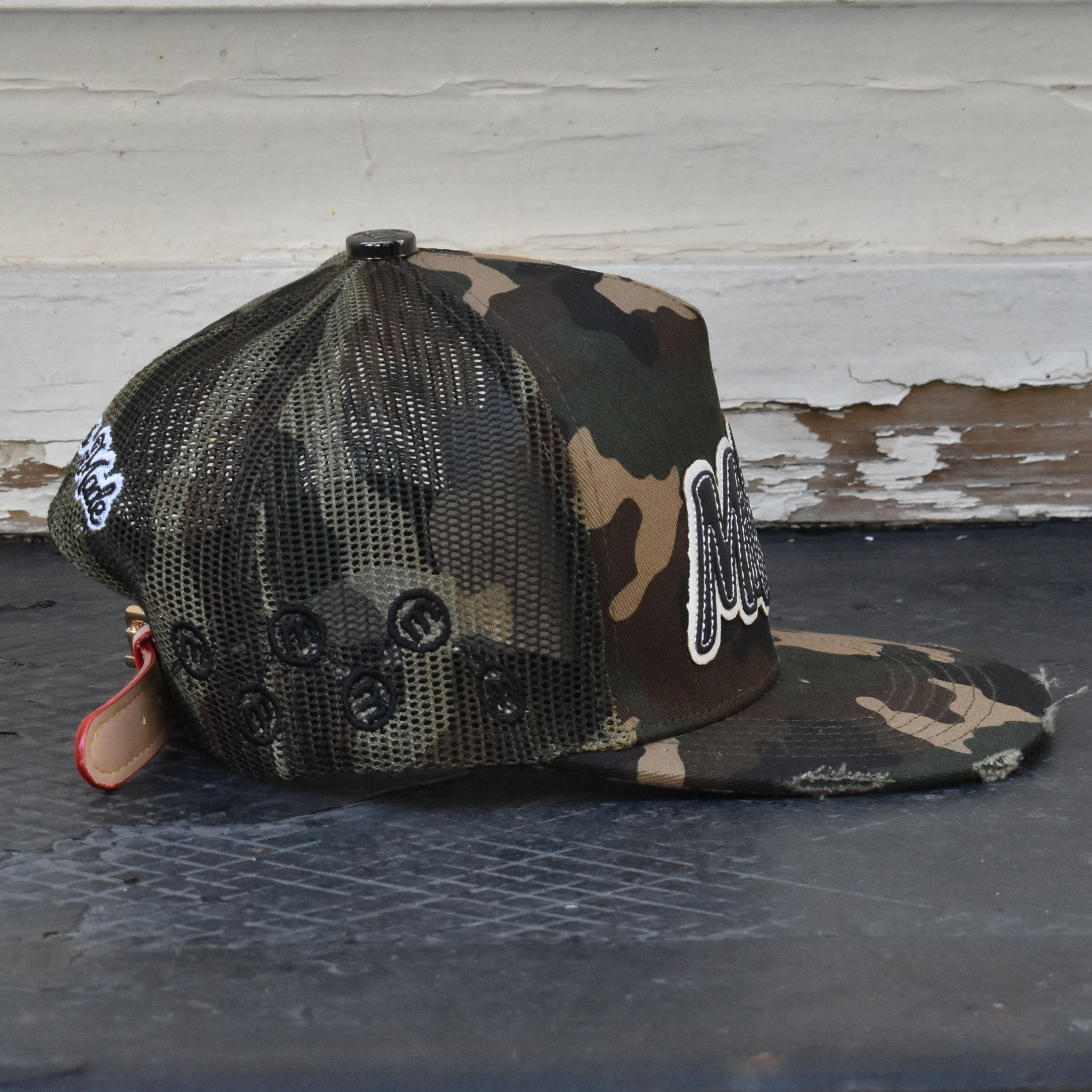 MILLIONS CAMO TRUCKER HAT